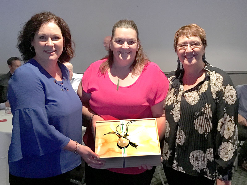Susan Impey, Opotiki College Principal, receives her gift box prize from CrestClean’s Caroline Wedding and Rachael Hanna. 