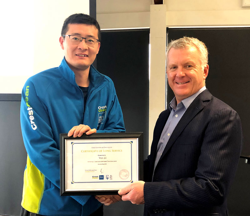 Wei Li receives his 7-year long service award from Grant McLauchlan, CrestClean’s Managing Director.