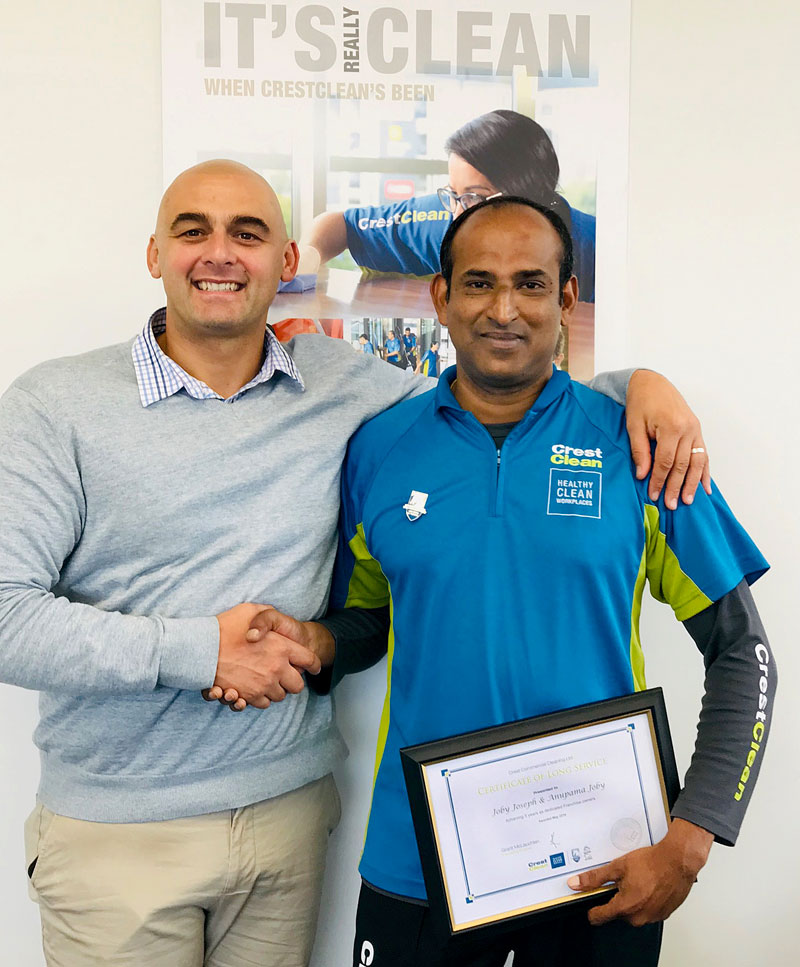 Joby Joseph receives his long service award from Tony Kramers, CrestClean’s Dunedin Regional Manager. 