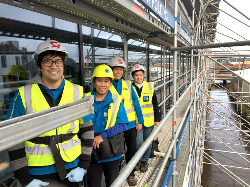 Martin DeGuzman, Marlene Madrid, Janeth Luna and Maricel DeGuzman cleaning windows on the new Kmart building.