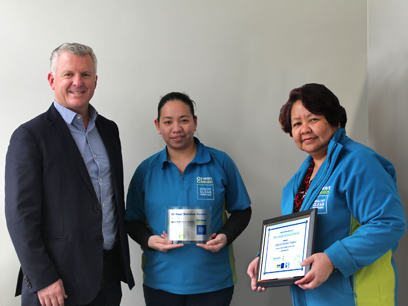 Agnes Vasquez and her daughter Christine receive their long service award from Grant McLauchlan, CrestClean’s Managing Director. 